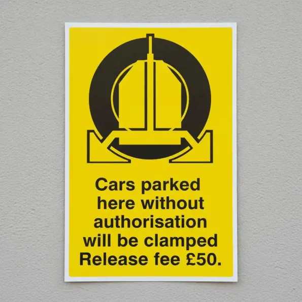Cars Parked Here without Authorisation will be Clamped - Release Fee £50